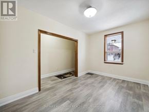 Toronto (Yorkdale-Glen Park) apartment for rent - A room with a doorway leading to another room and a window with a view of a building outside.