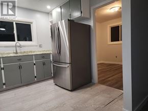 Cambridge apartment for rent - A kitchen with a stainless steel refrigerator and cabinets.