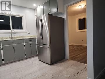 Cambridge apartment for rent - A kitchen with a stainless steel refrigerator and cabinets.