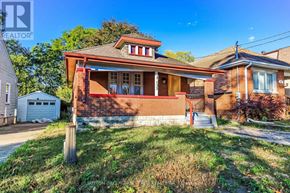 London East (East M) apartment for rent - A house with a red brick exterior and a white garage door is for sale.