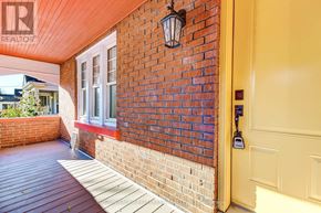 London East (East M) apartment for rent - A red brick wall with a white door and a black lantern on it.