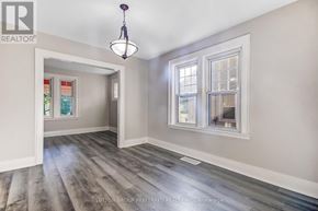 London East (East M) apartment for rent - A room with a grey floor and a chandelier hanging from the ceiling.