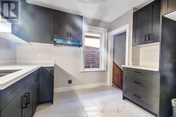 London East (East M) apartment for rent - A kitchen with black cabinets and a white counter top.