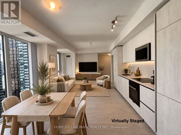 Toronto (Waterfront Communities) condo for rent - A modern kitchen with a dining table and chairs.