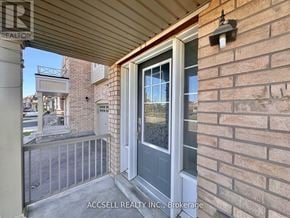 Brampton (Credit Valley) apartment for rent - A balcony with a glass door and a brick wall.