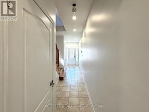 Brampton (Credit Valley) apartment for rent - A hallway with white walls and tiled flooring.