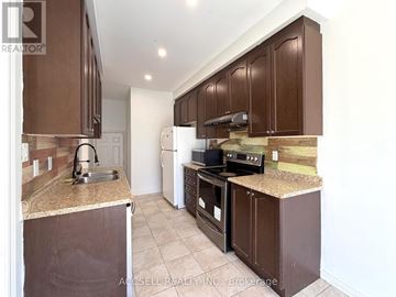 Brampton (Credit Valley) apartment for rent - A kitchen with brown cabinets and a granite counter top.