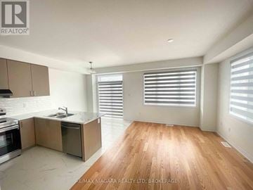 Thorold (Rolling Meadows) townhouse for rent - A kitchen with wooden floors and a stainless steel sink.