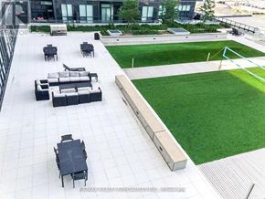 Mississauga (City Centre) condo for rent - A large outdoor seating area with black furniture and a green lawn.