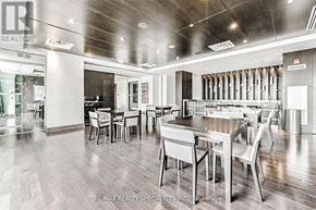 Mississauga (City Centre) condo for rent - A modern dining room with a wooden table and chairs.