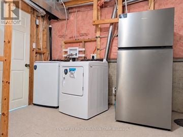 London North (North M) apartment for rent - A stainless steel refrigerator stands next to a white freezer and a white mini-fridge in a room under construction.