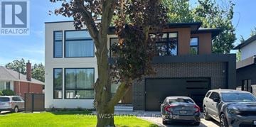 Oakville (Wo West) apartment for rent - A modern house with a large tree in front of it.