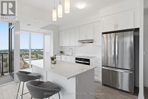 Mississauga (Clarkson) house for rent - A modern kitchen with white cabinets and a stainless steel refrigerator.