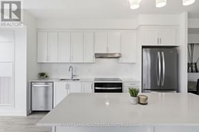 Mississauga (Clarkson) house for rent - A modern kitchen with white cabinets and stainless steel appliances.