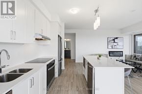 Mississauga (Clarkson) house for rent - A modern kitchen with white cabinets and a large island.