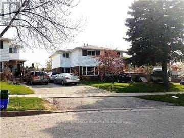 Kitchener apartment for rent - A residential street with houses and parked cars.