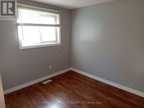 Kitchener apartment for rent - A room with a window and wooden flooring.