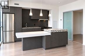 Toronto (Church-Yonge Corridor) condo for rent - A modern kitchen with a refrigerator, island, and stove.