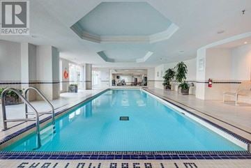 Toronto (Rosedale-Moore Park) condo for rent - A swimming pool inside a building with a tiled floor and walls.