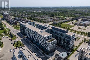 Oakville (Wm Westmount) condo for rent - A bird's eye view of a city with buildings and roads.