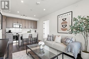 Oakville (Wm Westmount) condo for rent - A modern living room with a glass coffee table and a large painting on the wall.