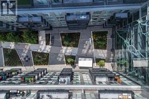 Oakville (Wm Westmount) condo for rent - A modern building with glass walls and a green roof.