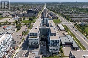 Oakville (Wm Westmount) condo for rent - A large building with a glass facade is the focal point of a busy intersection.