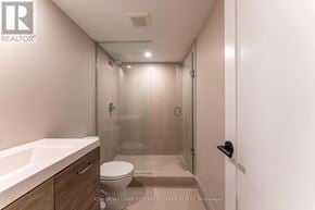 Toronto (Blake-Jones) apartment for rent - A bathroom with a toilet, sink, and walk-in shower.