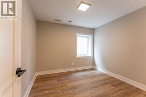 Toronto (Blake-Jones) apartment for rent - A room with a window and wooden flooring.