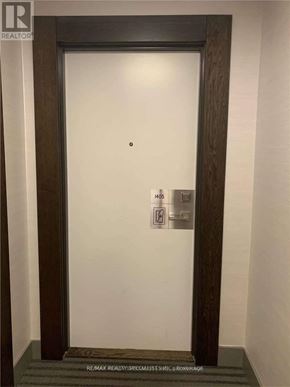 Mississauga (City Centre) condo for rent - A white door with a black frame and a small black dot on the door.