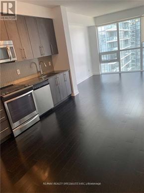 Mississauga (City Centre) condo for rent - A kitchen with a stove top oven and a microwave.