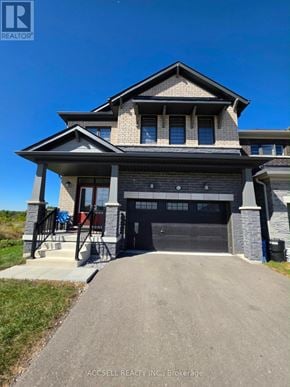 Haldimand apartment for rent - A modern house with a large front yard and a driveway leading to the garage.