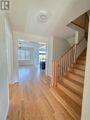 Haldimand apartment for rent - A wood staircase with a white wall on the side.