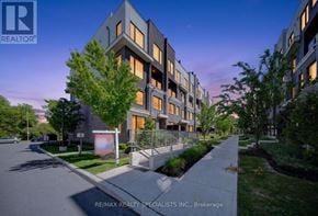 Mississauga (Erin Mills) townhouse for rent - A modern apartment complex is shown with the RE/MAX REALTY SPECIALISTS INC. logo in the foreground.