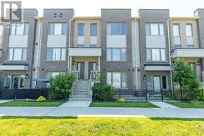 Pickering (Town Centre) townhouse for rent - A row of townhouses with a sign that says "REALTOR" on the front door.
