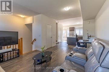 Pickering (Town Centre) townhouse for rent - A living room with a grey couch and a black coffee table.