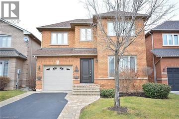 Oakville apartment for rent - A brick house with a black door and windows.