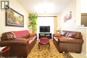 Oakville apartment for rent - A living room with brown leather couches and a television.