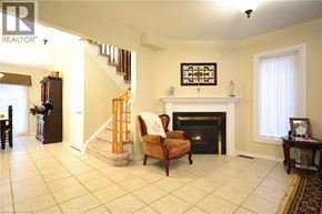Oakville apartment for rent - A living room with a fireplace and a chair.