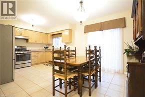 Oakville apartment for rent - A kitchen with a table and chairs in the middle.