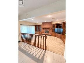 Burnaby apartment for rent - A balcony with a railing and a view of a brick wall.