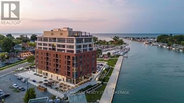 St. Catharines (Port Dalhousie) condo for rent - A building with the logo RE/MAX Niagara Realty Ltd. Brokerage on it.