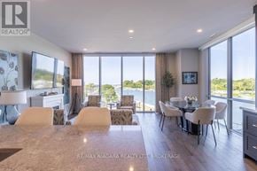 St. Catharines (Port Dalhousie) condo for rent - A well-lit, modern dining room with a view of the outdoors through large windows.