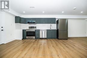 Ajax (Central West) apartment for rent - A kitchen with wooden floors and a white ceiling.