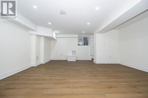 Ajax (Central West) apartment for rent - A large empty room with wooden floors and white walls.