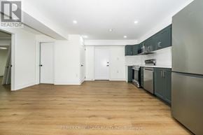 Ajax (Central West) apartment for rent - A kitchen with stainless steel appliances and white cabinets.