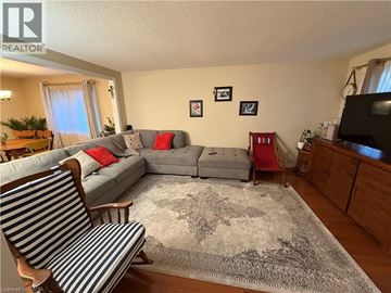 Cambridge apartment for rent - A living room with a grey couch and a striped chair.