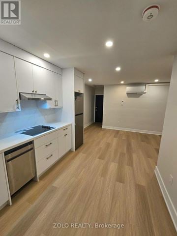 Toronto (Bedford Park-Nortown) apartment for rent - A kitchen with white cabinets and a wooden floor.