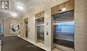 Toronto (Bendale) condo for rent - A hallway with elevators and a sign that says "REALTOR".