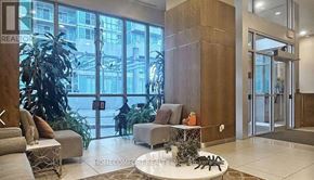Toronto (Bendale) condo for rent - A living room with a couch, a chair, and a coffee table.